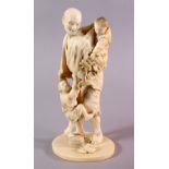 A JAPANESE MEIJI PERIOD CARVED IVORY OKIMONO - MAN AND CHILDREN, the man stood with his two young