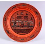 A 19TH / 20TH CENTURY INDIAN LACQUER PLATE, with scenes of figures and buildings, 26cm