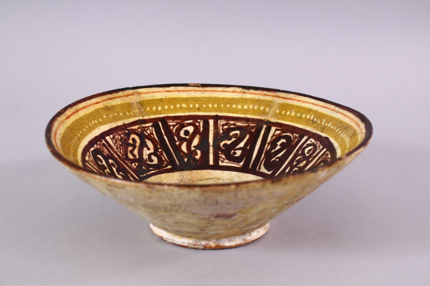 A 12TH CENTURY ISLAMIC / PERSIAN POTTERY BOWL, with brown decorated panels, upon biscuit colour - Image 3 of 6