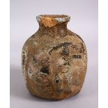 AN EARLY ROMAN STYLE POTTERY VASE, with relief decoration of a face, 14cm high x 12cm