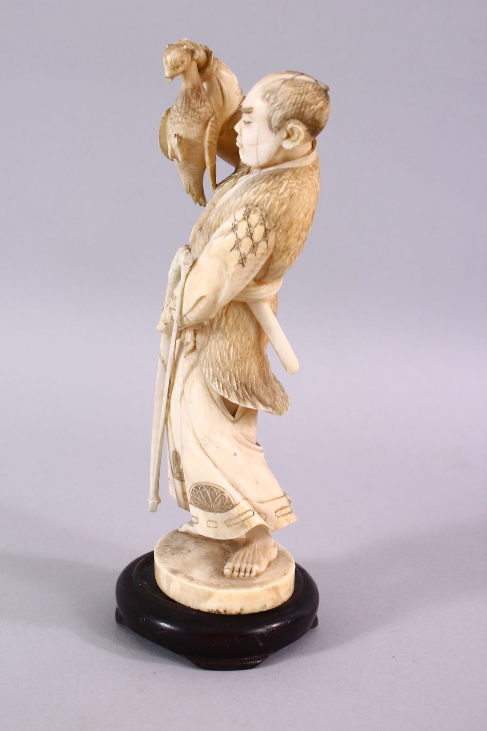 A FINE JAPANESE MEIJI PERIOD CARVED IVORY OKIMONO OF A HUNTSMAN, stood holding his catch with his - Image 4 of 6