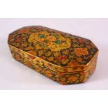 A 19TH CENTURY PERSIAN LACQUER LIDDED BOX, with floral decoration, 14cm x 7cm.