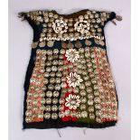 A 19TH CENTURY TURKISH SILVER ONLIAD CHILDS DRESS, with silver roundel and shell applications.