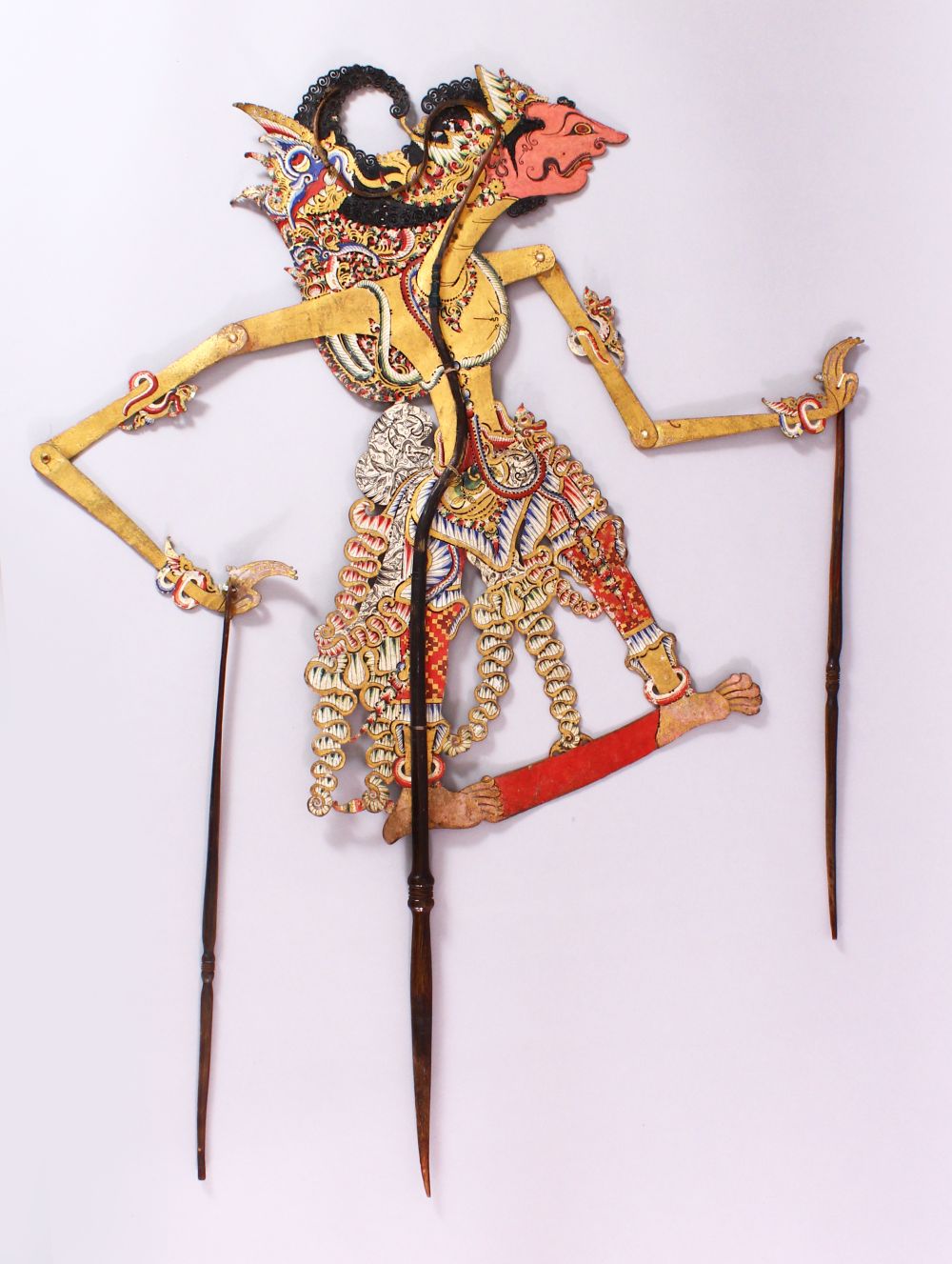 A LARGE 19TH CENTURY INDONESIAN SHADOW PUPPET WITH RHINO HORN STICKS, 73cm.