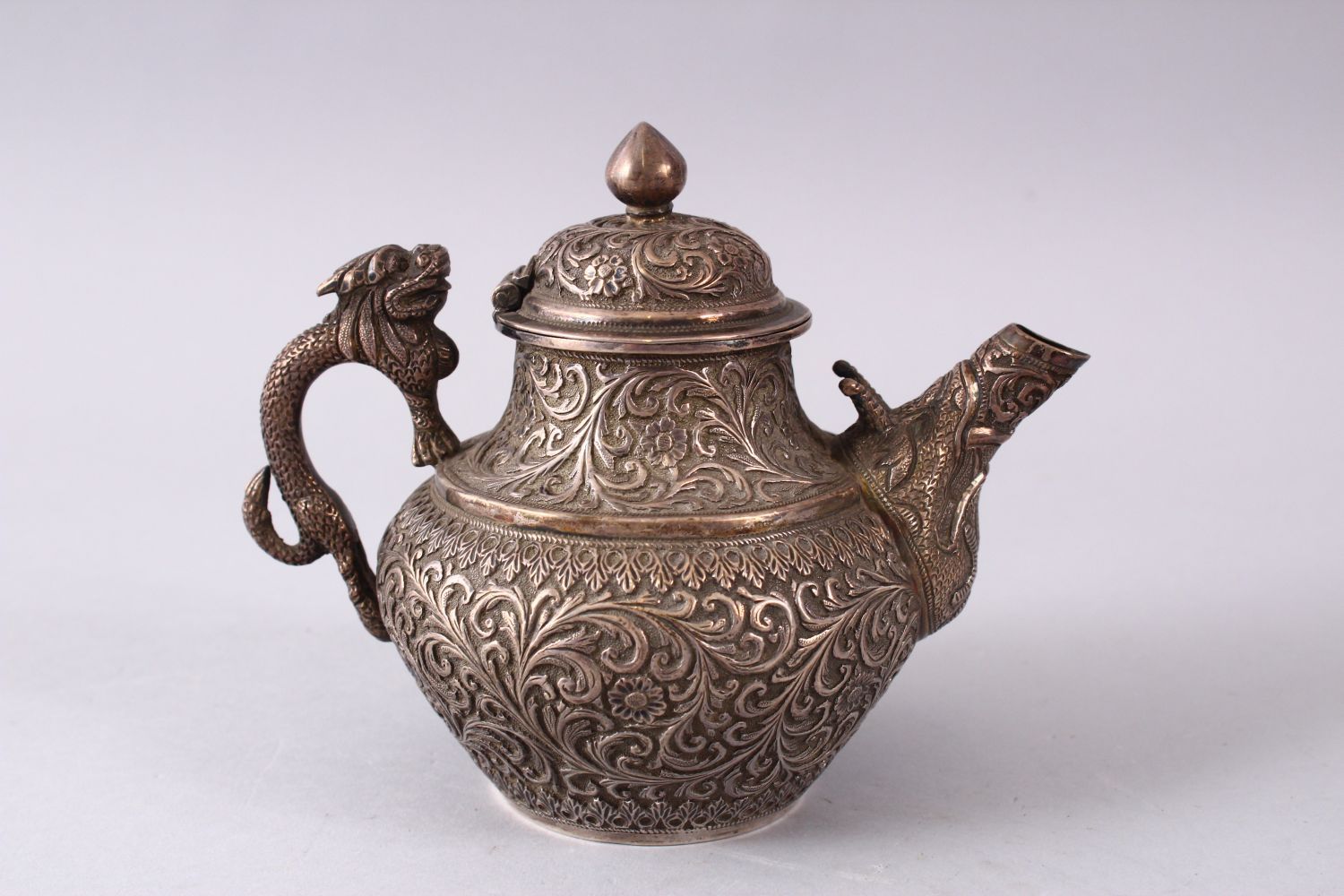 A GOOD 19TH CENTURY TURKISH SOLID SILVER TEAPOT carved with formal foliage and a dog style handle, - Image 3 of 10