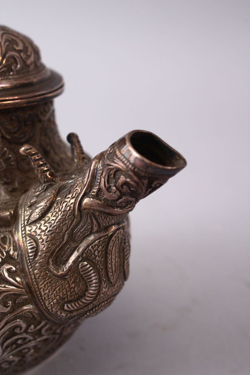 A GOOD 19TH CENTURY TURKISH SOLID SILVER TEAPOT carved with formal foliage and a dog style handle, - Image 8 of 10