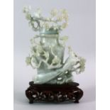 A CHINESE CARVED JADE FLORAL URN & COVER, carved with a display of flora and birds, upon a carved