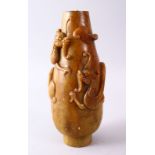 A 19TH CENTURY CHINESE CARVED SOAPSTONE VASE WITH CHILONG, the body with climbing chilong, top