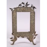 AN ISLAMIC PERSIAN STYLE WHITE METAL PICTURE FRAME, with decoration of ram, 19.5cm x 12cm .
