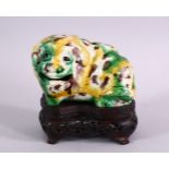 A CHINESE SANCAI GLAZED POTTERY ROSE WATER DROPPER FIGURE, depicting a mythical beast, upon its