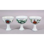 THREE CHINESE DOUCAI & FAMMILE VERTE DECORATED PORCELAIN STEM CUPS, one decorated with dragons,