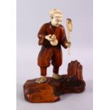 A JAPANESE MEIJI PERIOD CARVED IVORY AND WOOD OKIMONO OF A WOOD CUTTER, stood holding his axe