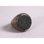A 19TH CENTURY ISLAMIC CARVED JADE INTAGLIO STYLE & SILVER RING, with carved inset jade with