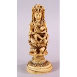 A JAPANESE MEIJI PERIOD CARVED IVORY FIGURE OF A DEITY - KWANNON - in a seated position upon a
