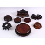 A MIXED LOT OF EIGHT LARGE CHINESE CARVED HARDWOOD STANDS, various styles and sizes. 18cm down to