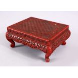 A 19TH CENTURY CHINESE CINNABAR LACQUER STAND, carved with a greek key and folate design, 13cm x