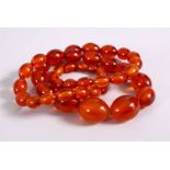 A SET OF CHINESE QING AMBER PRAYER BEADS, with 44 graduating carved beads, approx. 70cm open