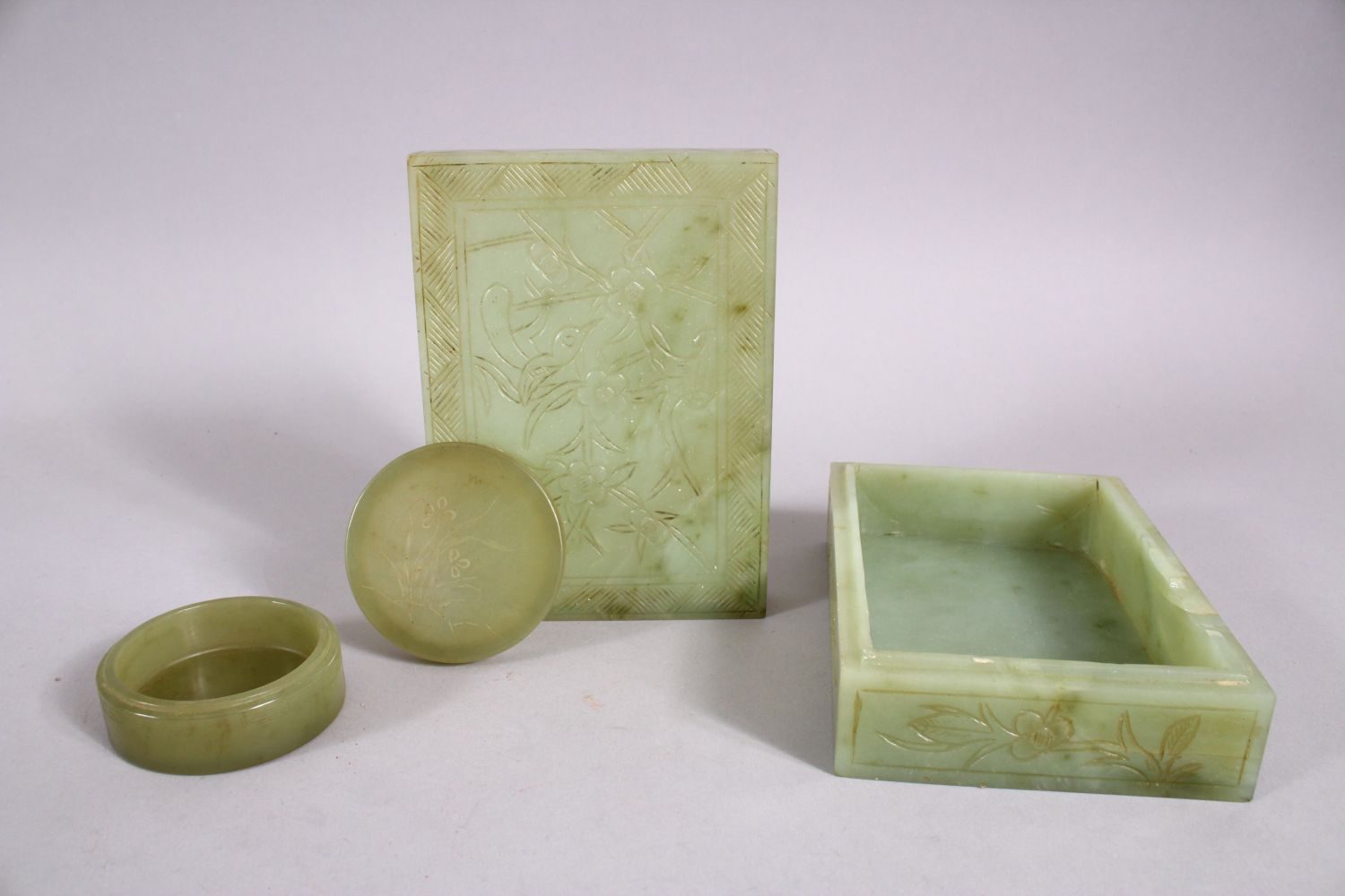 TWO CHINESE CARVED JADE BOXES, one of cylindrical form and carved with flora, 6cm, the other of - Image 2 of 2