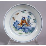 A CHINESE DOUCAI PORCELAIN PLATE - depicting two figures in a landscape with bats, six character