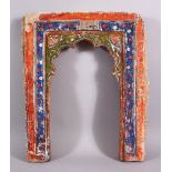 A 19TH CENTURY ISLAMIC INDIAN MIHRAB SHAPED POTTERY TILE, with polychrome decoration, 43.5cm high