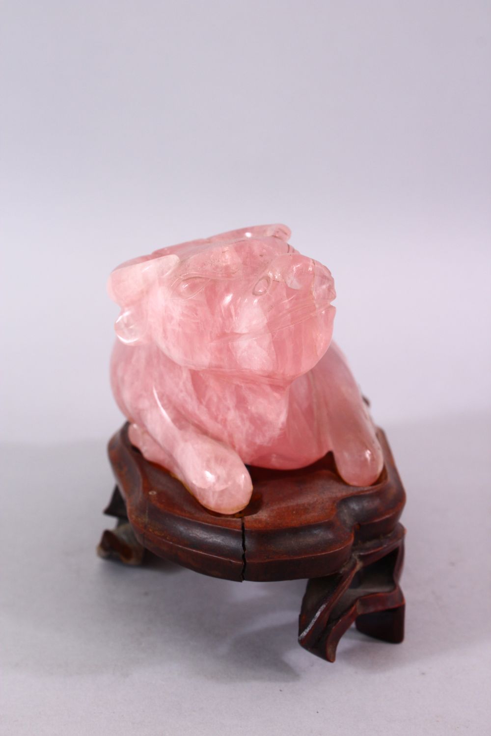 A CHINESE CARVED ROSE QUARTZ FIGURE OF A RECUMBENT OXEN, in a led position upon a carved hardwood - Image 2 of 5