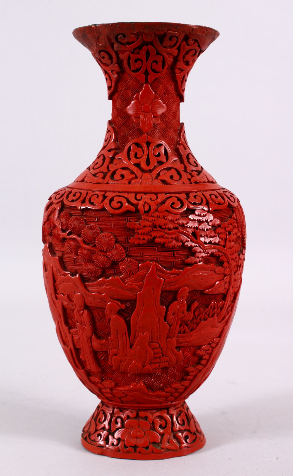 A 19TH / 20TH CENTURY CHINESE CINNABAR LACQUER VASE, decorated with figures in a landscape with