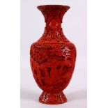 A 19TH / 20TH CENTURY CHINESE CINNABAR LACQUER VASE, decorated with figures in a landscape with