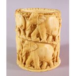 A JAPANESE MEIJI PERIOD CARVED IVORY ELEPHANT TUSK VASE / POT, carved with a heard of elephants in