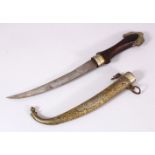 A GOOD ISLAMIC MOROCCAN DAGGER, with a carved gilt metal sheath, and carved wood handle, 40cm