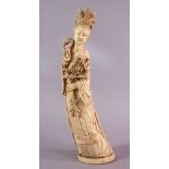 A LARGE 19TH CENTURY CHINESE CARVED IVORY FIGURE OF GUANYIN, stood holding a display of flora, the