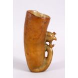 A CHINESE 20TH CENTURY CARVED SOAPSTONE LIBATION CUP, with a phoenix head carved handle, 15cm high.