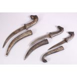 A LOT OF THREE 19TH CENTURY SILVER INLAID NIELLO DAGGERS, One with an elephant head handle, with a