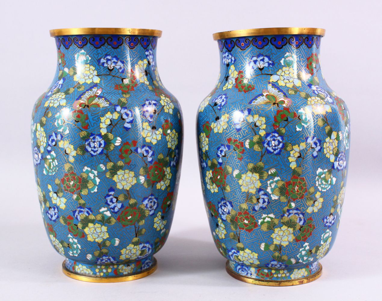 A LARGE PAIR OF 19TH / 20TH CENTURY CHINESE CLOISONNE VASES, each decorate with an array of flora