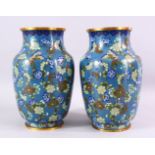 A LARGE PAIR OF 19TH / 20TH CENTURY CHINESE CLOISONNE VASES, each decorate with an array of flora