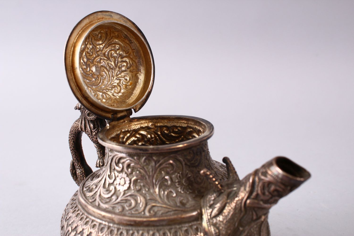 A GOOD 19TH CENTURY TURKISH SOLID SILVER TEAPOT carved with formal foliage and a dog style handle, - Image 7 of 10