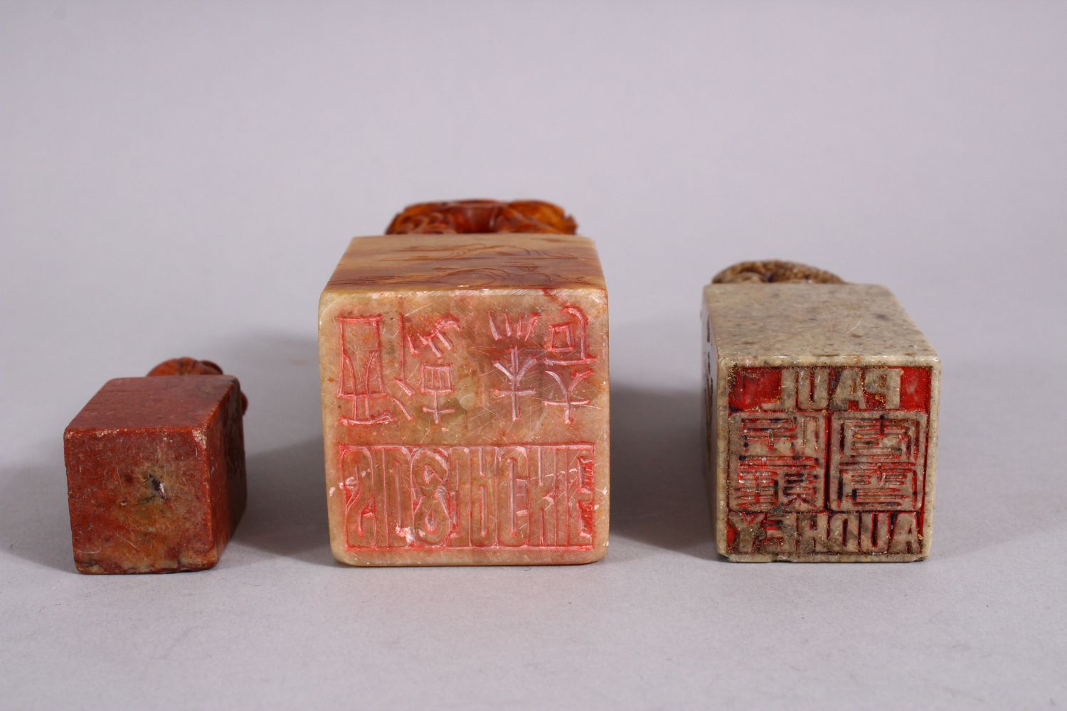 THREE CHINESE CARVED SOAPSTONE SEALS, each carved with dragons and lion dogs, two bases carved - Image 4 of 4
