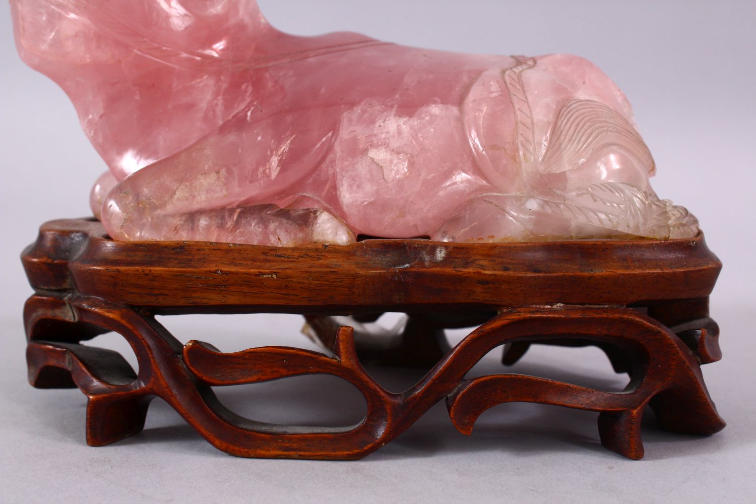A CHINESE CARVED ROSE QUARTZ FIGURE OF A RECUMBENT OXEN, in a led position upon a carved hardwood - Image 5 of 5