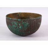 AN EARLY PERSIAN POSSIBLY SASSANIAN OR AKHAMINID BRONZE BOWL, with a ribbed body, 15cm