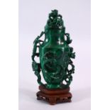 A CHINESE CARVED MALACHITE LIDDED VASE AND COVER, carved with kylin & stylized clouds and ruyi, with
