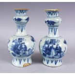 A PAIR OF CHINESE TRANSITIONAL BLUE & WHITE PORCELAIN VASES, each decorated with scenes of figures