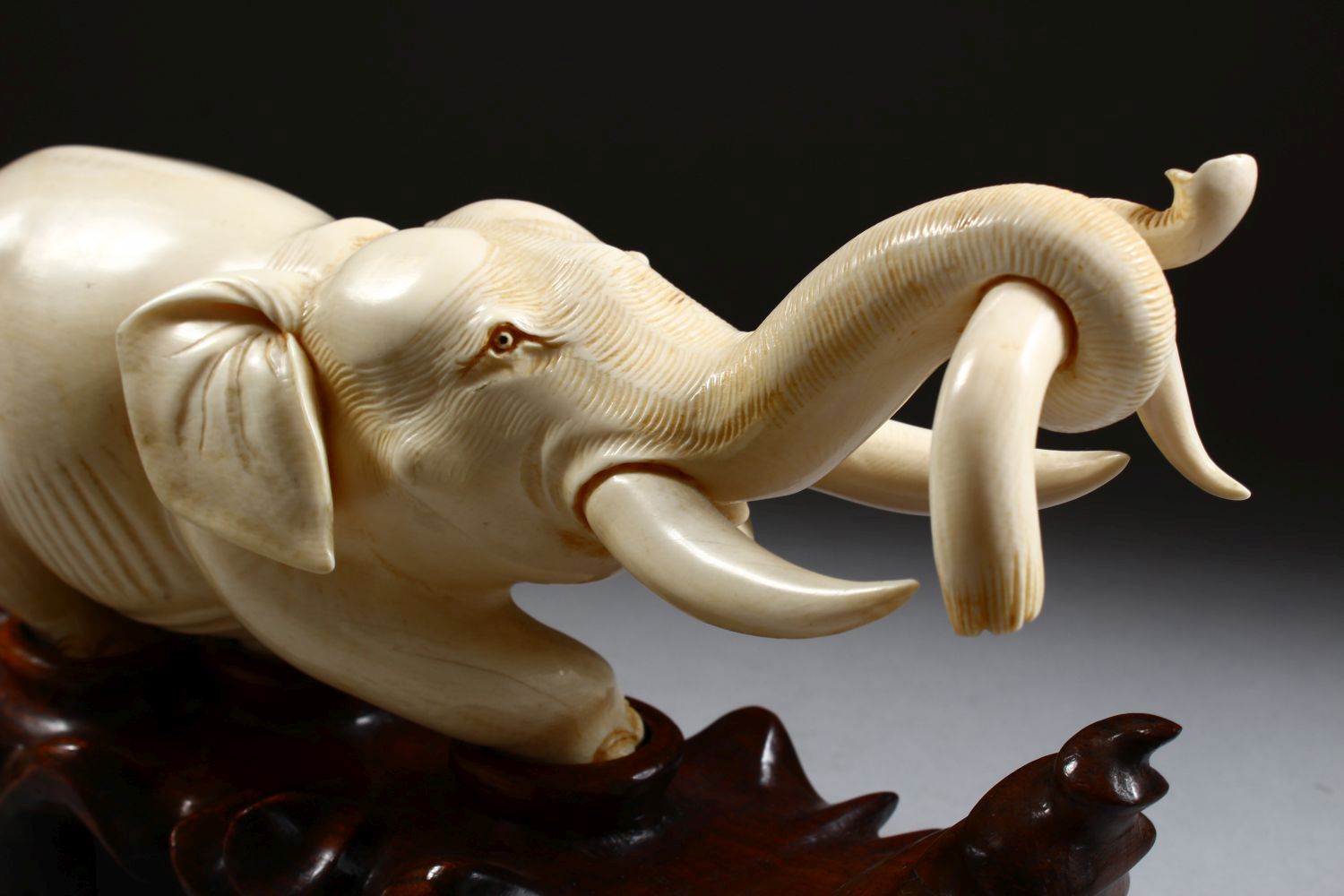 A 19TH CENTURY CHINESE CARVED IVORY FIGURE OF AN ELEPHANT, the elephant holding on to the horn of - Image 5 of 9