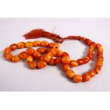 A 19TH CENTURY ISLAMIC CARVED AMBER PRAYER BEAD NECKLACE, with 46 carved beads, and three spacers,