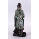 A 19TH CENTURY OR EARLIER CHINESE CARVED WOOD AND LACQUER FIGURE OF A SCHOLAR, with a mythical beast