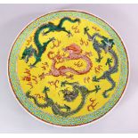 A 19TH CENTURY CHINESE FAMILLE JAUNE PORCELAIN DRAGON CHARGER, with central decoration of four