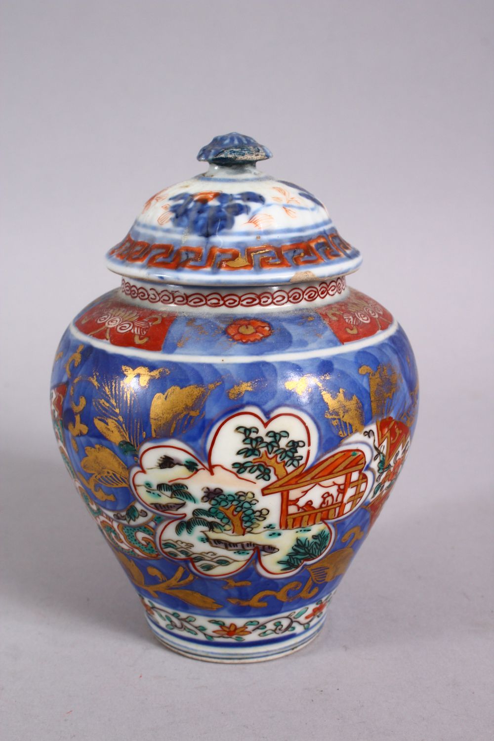 AN 18TH CENTURY JAPANESE BLUE, WHITE AND IRON RED PORCELAIN ARITA JAR & COVER, with landscape - Image 3 of 6