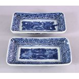 A PAIR OF JAPANESE MEIJI PERIOD BLUE & WHITE RECTANGULAR PORCELAIN DISHES - each decorated with