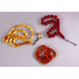 A COLLECTION OF 2 ISLAMIC POSSIBLY OTTOMAN AMBER PRAYER BEADS AND ANOTHER POSSIBLY CHERRY AMBER