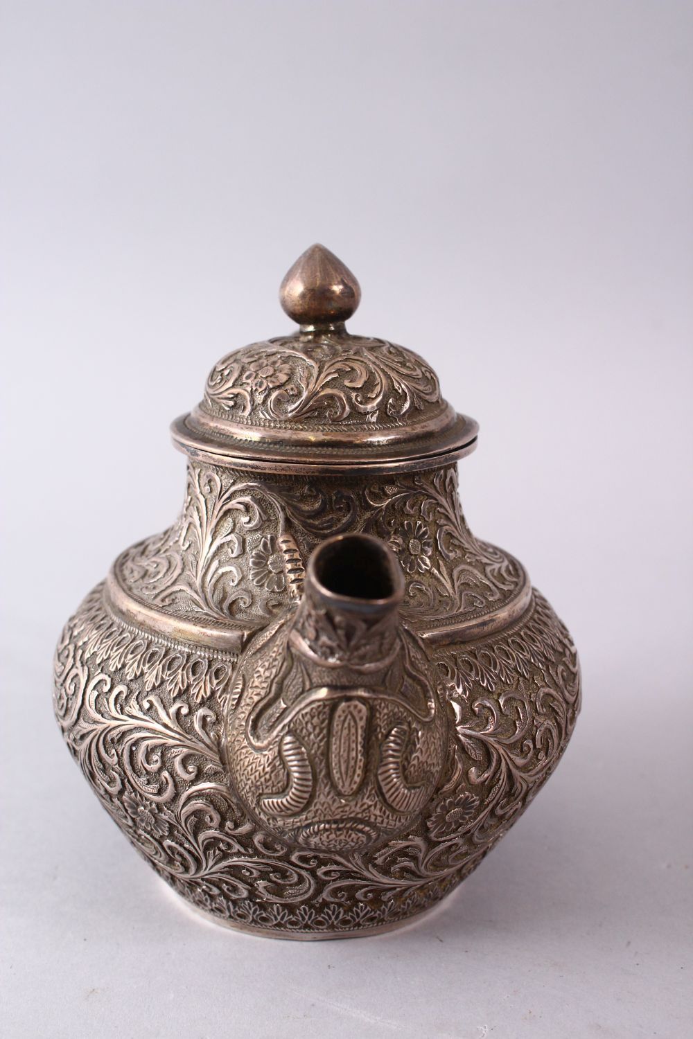 A GOOD 19TH CENTURY TURKISH SOLID SILVER TEAPOT carved with formal foliage and a dog style handle, - Image 2 of 10