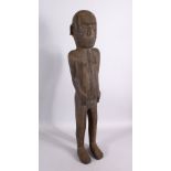 AN AFRICAN CARVED WOODEN NATIVE FIGURE, with piercing's, 80cm.