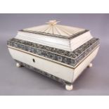 A 19TH CENTURY INDIAN CARVED IVORY LIDDED SEWING BOX, with bands of black stained and inlaid ivory